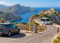 Rental car, access barrier and shuttle bus on the road to Cap de Formentor lighthouse
