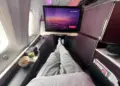 Virgin Atlantic Upper Class seat with in-flight screen, drink and snack beside the window