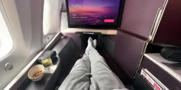 Virgin Atlantic Upper Class seat with in-flight screen, drink and snack beside the window
